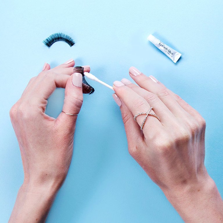 applying eyelash glue with a q tip.jpeg